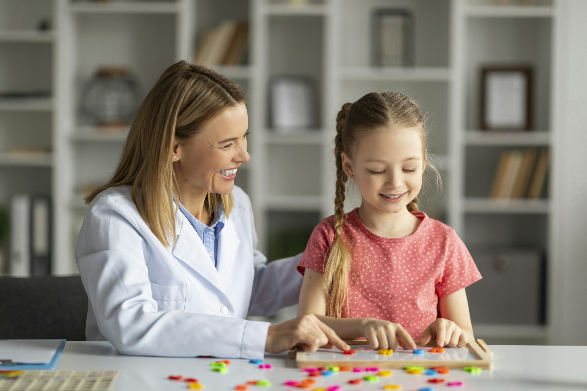 Dyslexia Treatment. Pediatric Neurologist Lady Having Therapy Session With Cute Little Girl